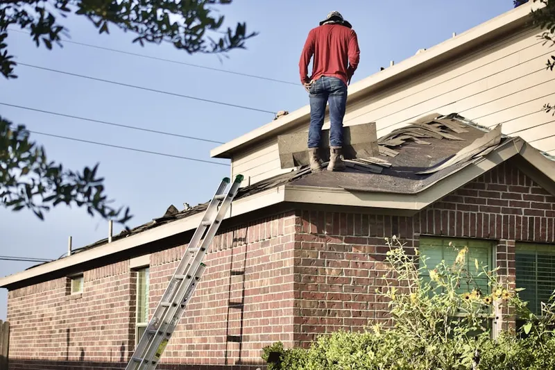 Professional roofer working on a residential roof in Charleston East